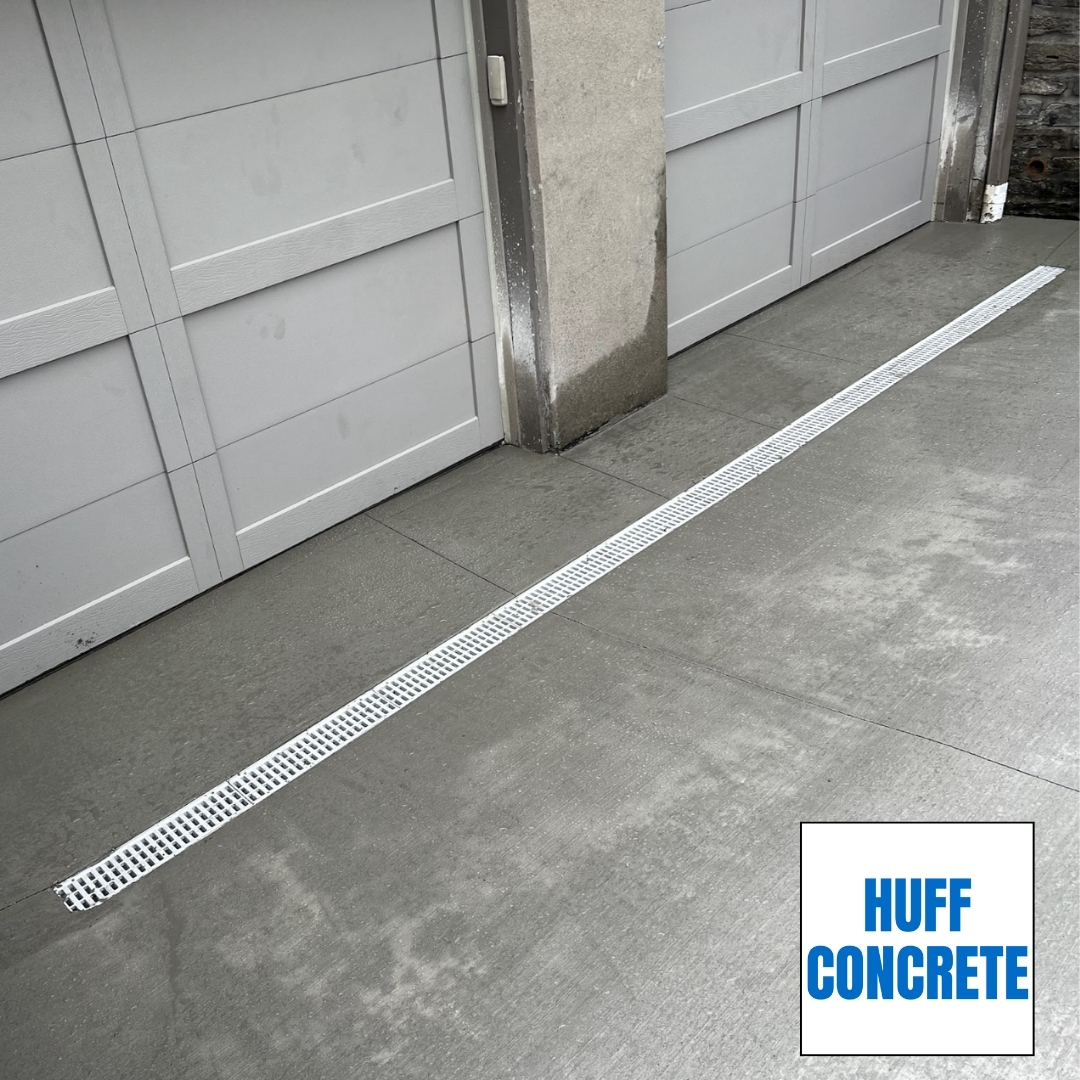 Trench drain installed across concrete driveway in Madeira Ohio to prevent garage water intrusion