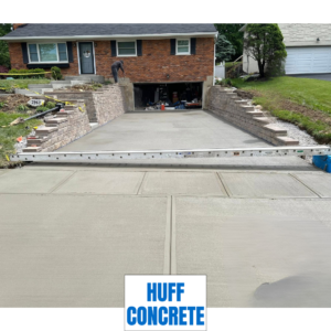 Completed concrete driveway, steps, and Geogrid retaining walls at Madeira Ohio home by Huff Concrete