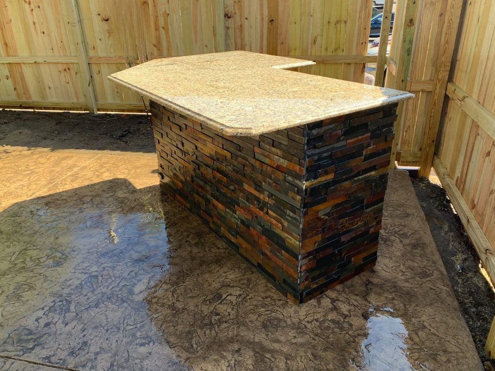bronze color stamped concrete patio with custom made serving bar