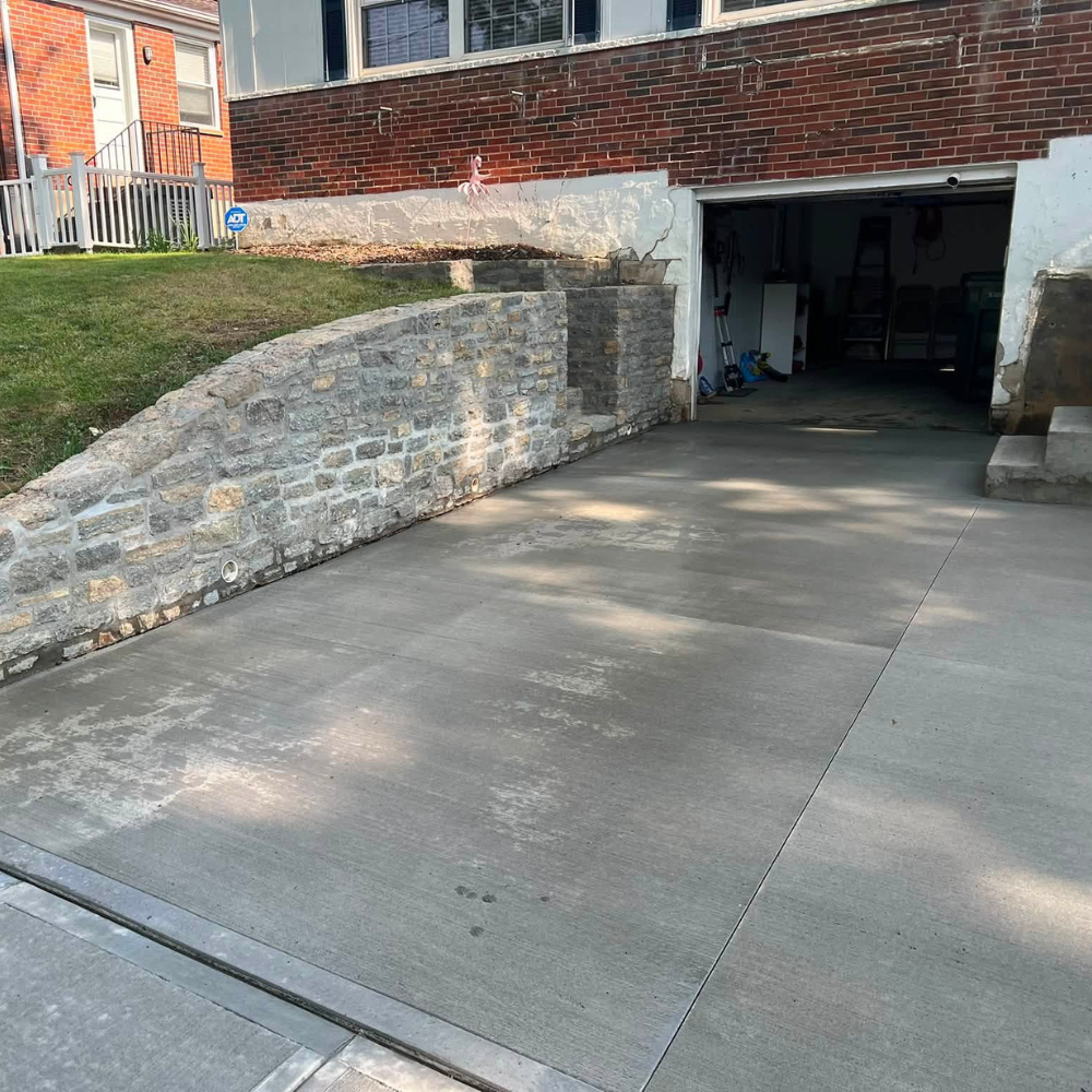 new concrete driveway and retaining wall in Madisonville