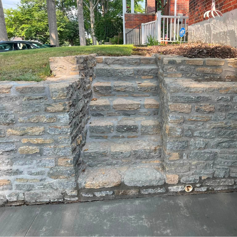 Rebuilt stone retaining wall and front staircase in Madisonville